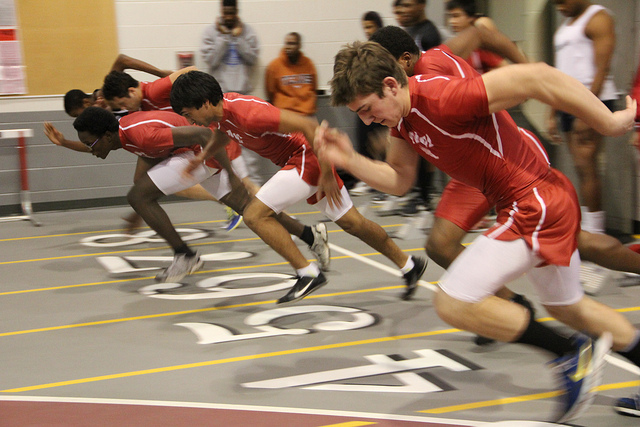 Boys pushing of the blocks to start off their run.