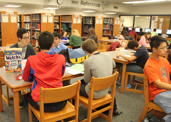 Students sit and socialize in the library. 
