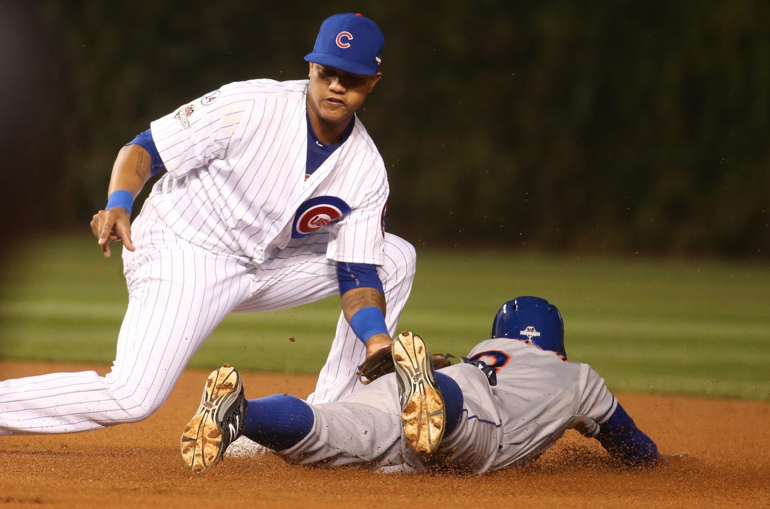 Chicago Cubs second baseman Starlin Castro, left, tags out the New York Mets' Curtis Granderson on an attempted steal in the first inning during Game 3 of the NLCS on Tuesday, Oct. 20, 2015, at Wrigley Field in Chicago. (Brian Cassella/Chicago Tribune/TNS)