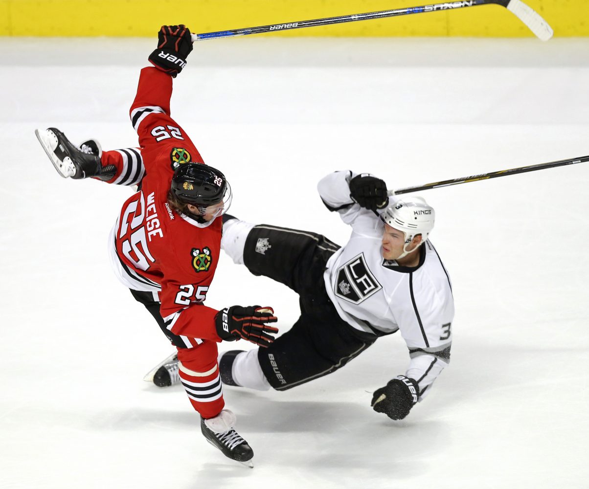 Chicago Blackhawks right wing Dale Weise (25) collides with Los Angeles Kings defenseman Brayden McNabb (3) during the second period on Monday, March 14, 2016, at the United Center in Chicago. (Nuccio DiNuzzo/Chicago Tribune/TNS)