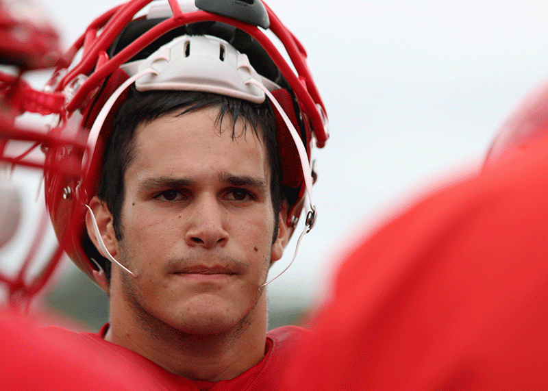 Senior captain Matt Galanopoulos meets with his football team during the pre-season scrimmage. Photo by Sana Kadir