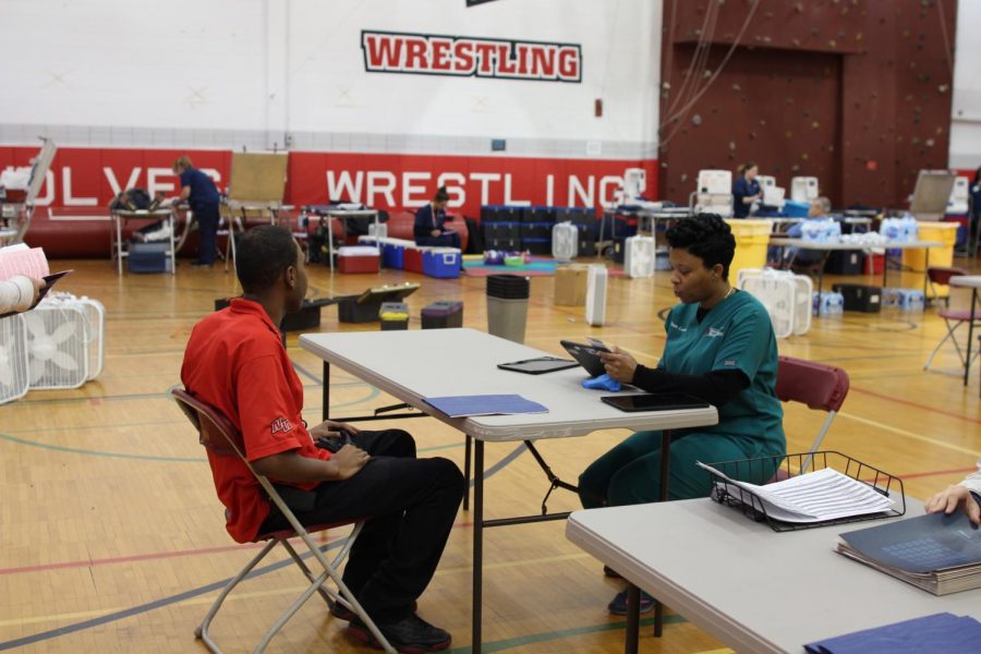 Niles West security guard signing up to donate blood to the blood drive from past years. 