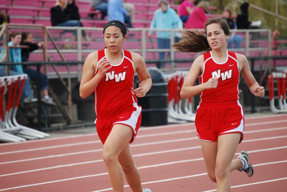 Girls Varsity Track push through a tough race on a Saturday morning in a conference meet. 