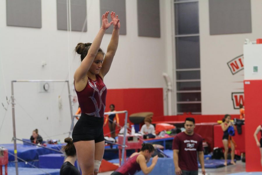 Junior Jasmine Dirks gets ready to perform her routine on the beam. 