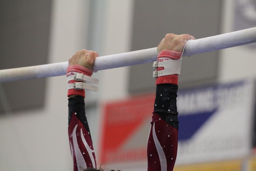 West gymnast competes on uneven high bars. 