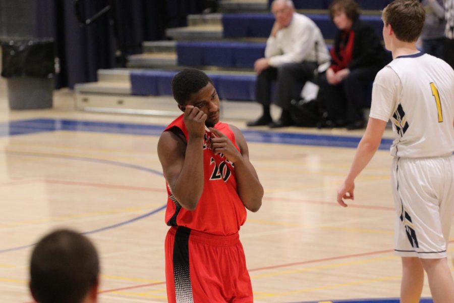 Senior Clyde Singleton cools down before the start of the fourth quarter. 