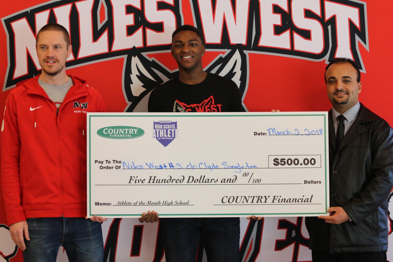 Clyde Singleton gets awarded $500 on behalf of Country Financial for Athlete of the Month.
