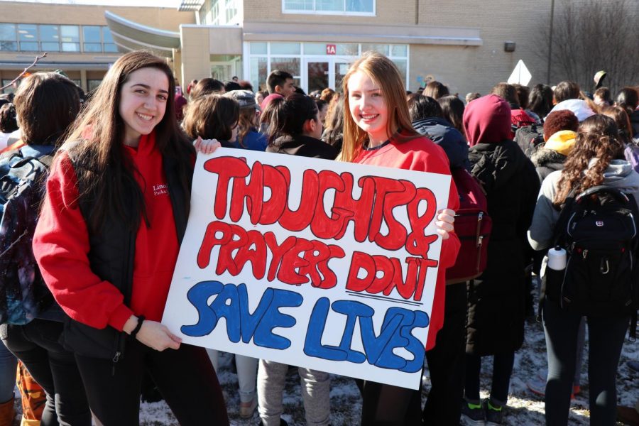 Student organizers Anna Darville and Katrina Grunst express their opinions while protesting outside Niles West. 
