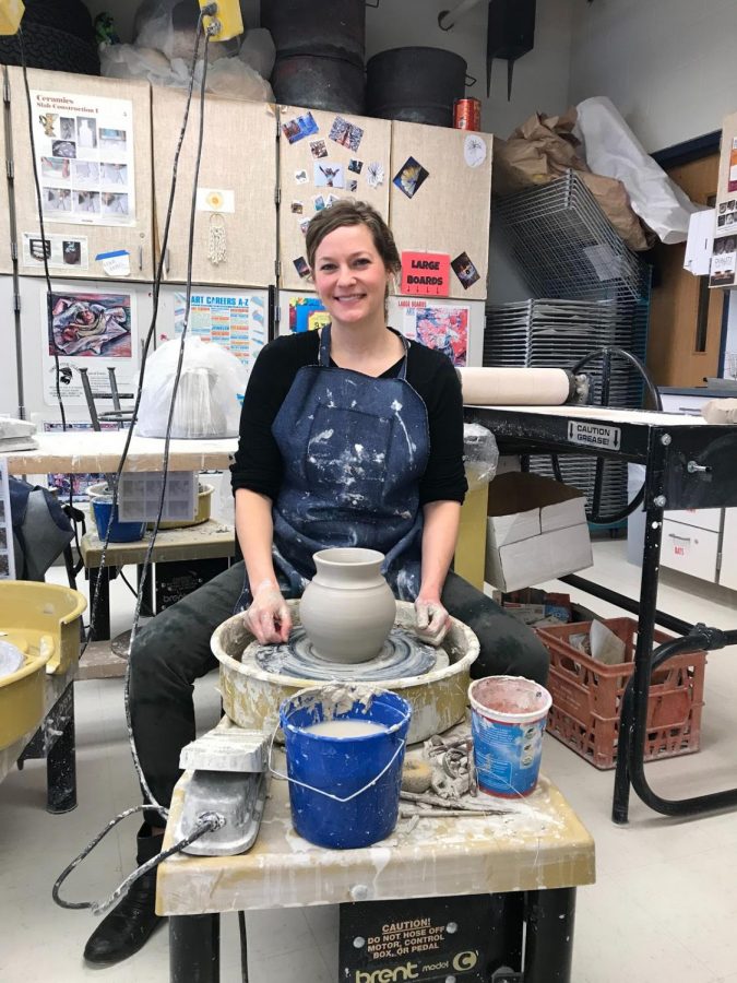 Art teacher Barbara Wismer showing off her pottery work.