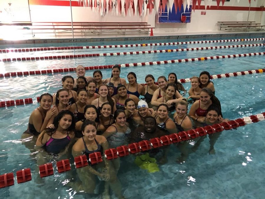 Sewell poses with West's Varsity Girls Swimming Team.