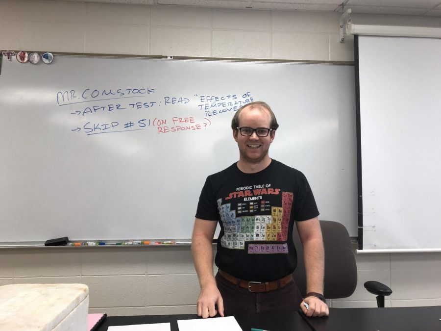 Physics teacher Anthony Comstock stands with a smile on his face before the start of class.