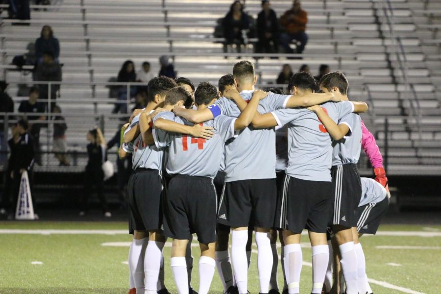 Players huddling before the game starts to have a great game   "Go wolves!" 