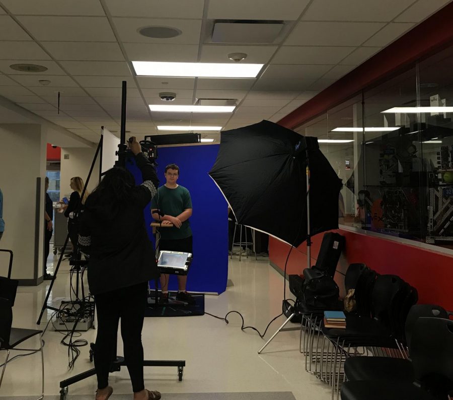 Students getting yearbook pictures taken during school.