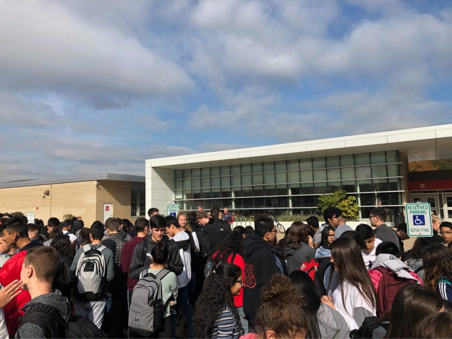 Students standing outside due to the fire alarm interrupting class.