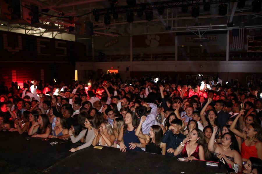 Students crowd the stage to watch the DJ and be closer to the music