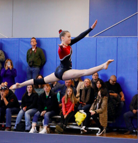 Freshman Melanie Brill preforming her floor routine. 