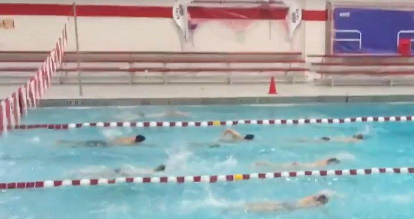 The boys swim team eagerly awaits for the start of their season. 