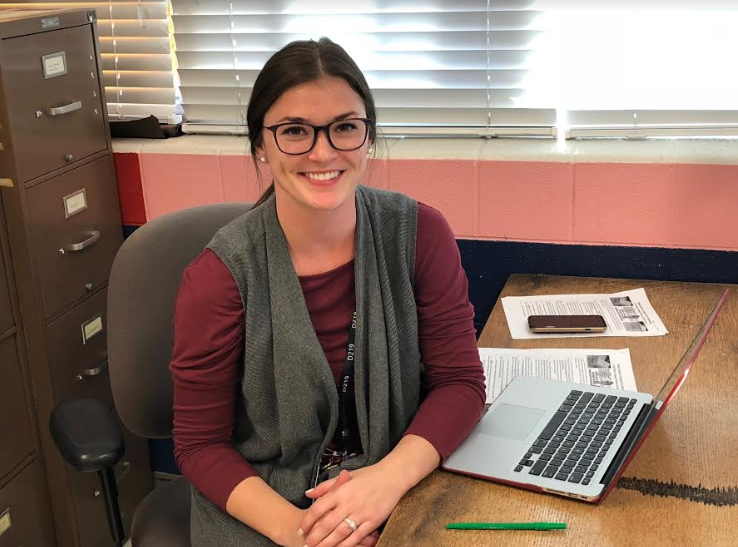 Social Studies teacher Linda Mulligan sits at her desk, eager to start the day.