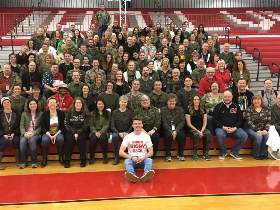 Staff members pose in the main gym sporting camo in support of Mark Rigby.