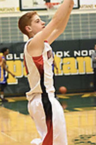 Junior Andrew Pabst taking a shot during a basketball game against Glenbrook North