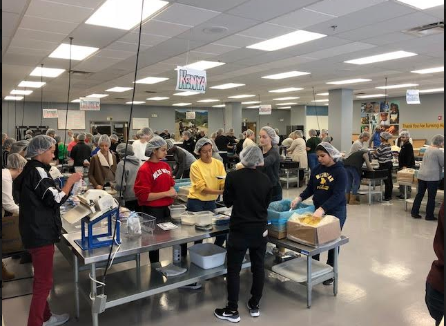 Civics students packing nutritional meals for malnourished children in various countries at the Feed My Starving Children Packing site in Libertyville, IL