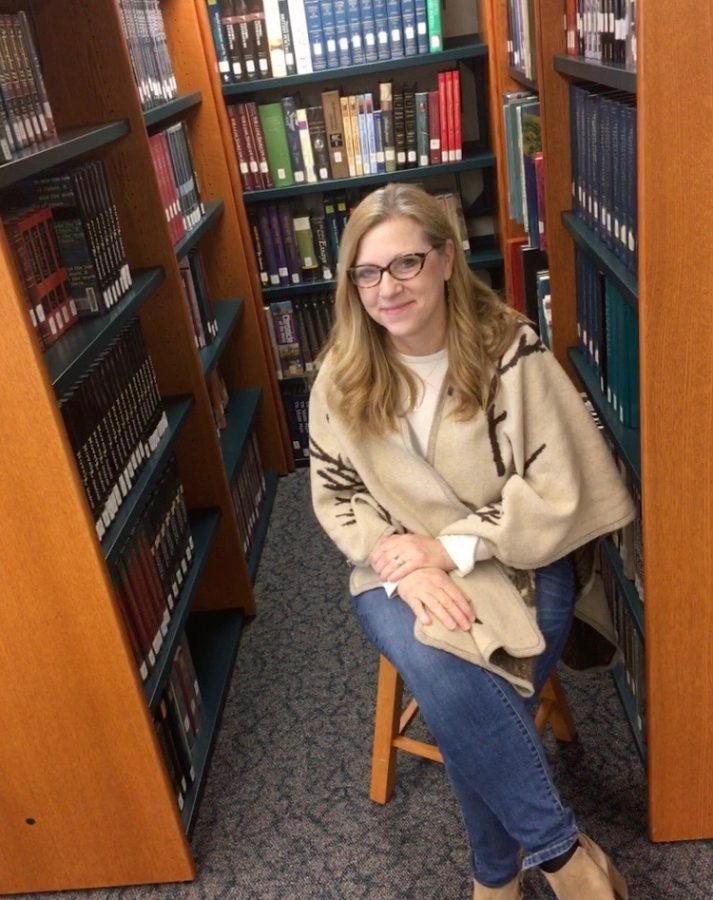 Amidst the books in the lit center, English teacher Sally Graham poses for a picture. 