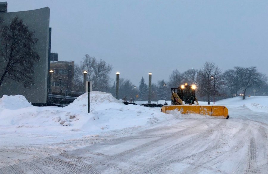 The Niles West faculty parking lot being plowed before school.