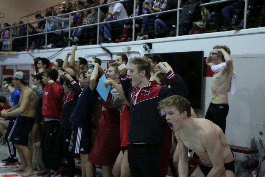 The swim team cheering on the divers. 