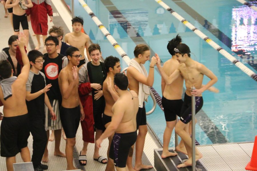 Swimmers showing sportsmanship after the meet.