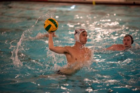 Junior Jake Cachila shooting a goal during a game.