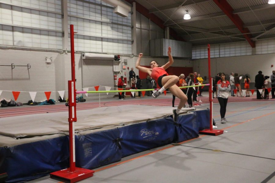 Senior Kristianna Bliznakov finishing her high jump during the meet. 