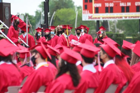 Students patiently waiting their turn to walk down the stage.