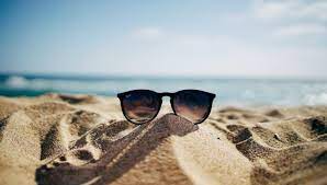 Image of sunglasses on sand