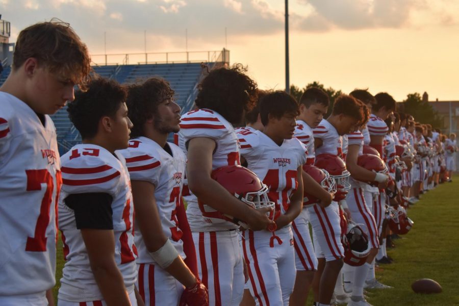August 27, 2021—Varsity boys football team standing together during the national anthem. 