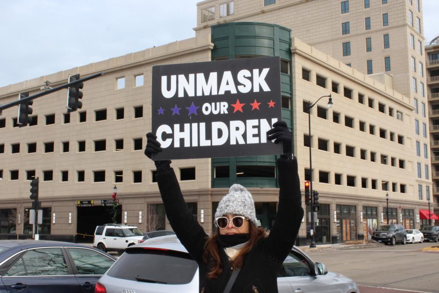 In a @dudewithsign style, one woman carried a sign to Unmask our children.
