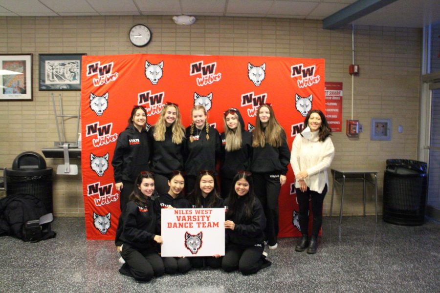 NWDT posing with their coach and their dance team banner. 