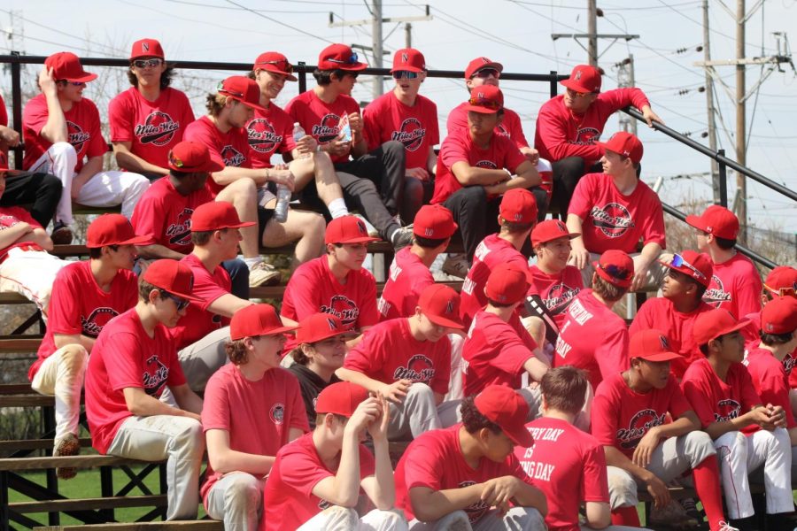The Niles West baseball teams sit in the stands awaiting the ceremony. 