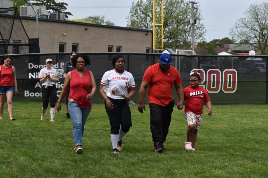 Londyn LaVallias walks down the field towards her coach with her family.