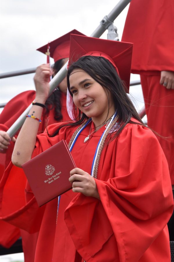 Emma Kalchik smiles for the camera after walking across the stage.
