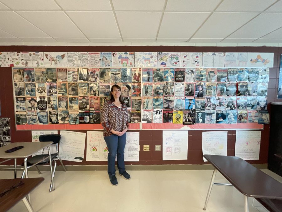 Social+Studies+teacher+Dana+Kanwischer+stands+in+front+of+her+prized+wall+of+magazine+covers.+Shes+collected+the+various+pages+over+the+course+of+her+35-year+teaching+career.