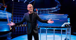 Host Howie Mandel posing in front of the game show platform