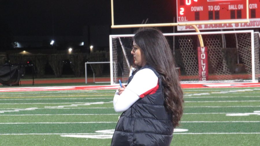 Red teams coach, Reine Hanna observing her team on the field. 