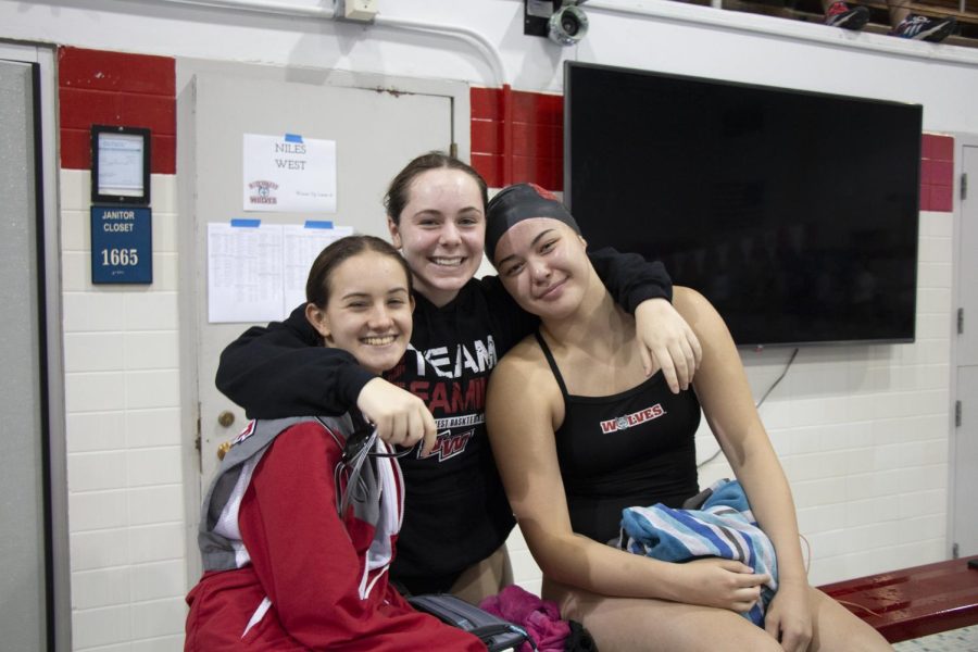 Swimmers Vaughn Holleran, Lily Earle, and Maya Iusco pose for a picture. 