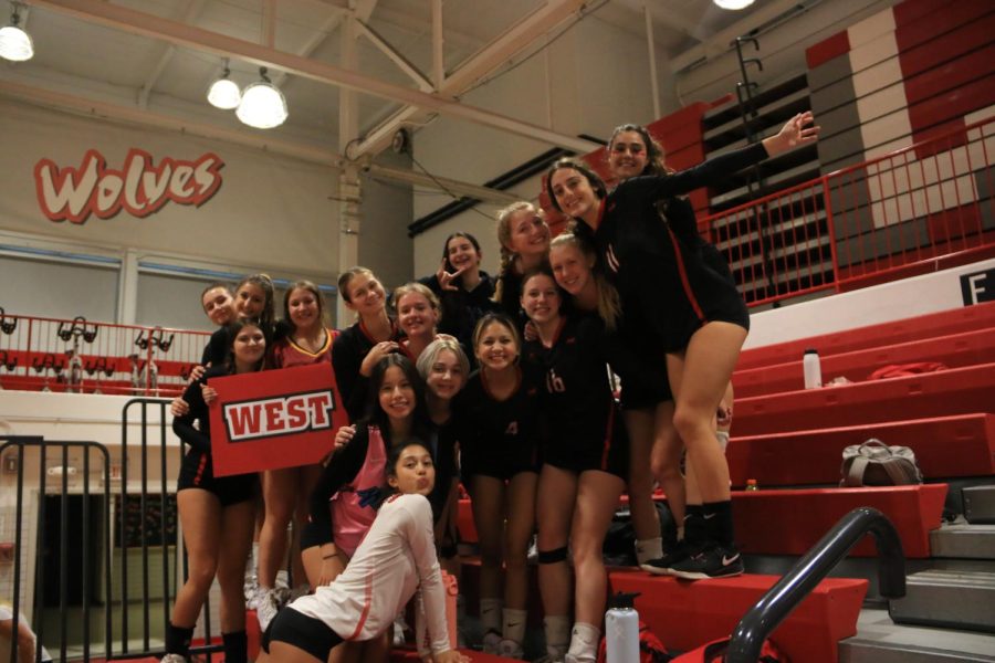 Varsity posing in the stands as JV is finishing up their game.
