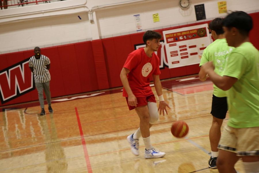 Mikey Massih dribbles the ball up the court.