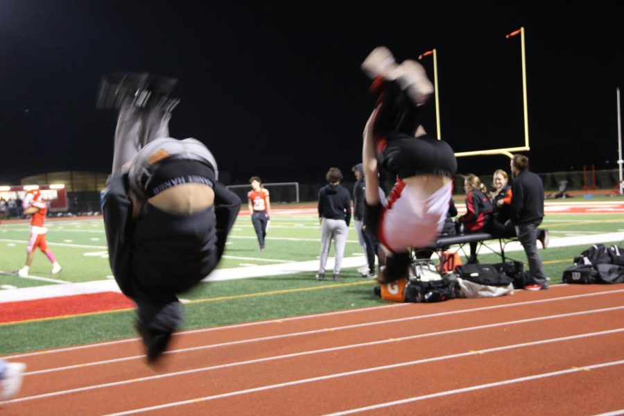 Cheer brothers flip it out during the game.