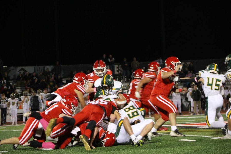 Niles West offense jumping on the player pile to get extra yards on the play. 