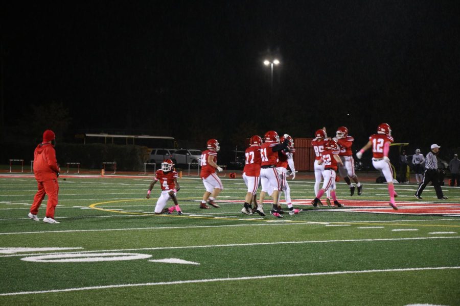 The football players getting hyped to get on the field.