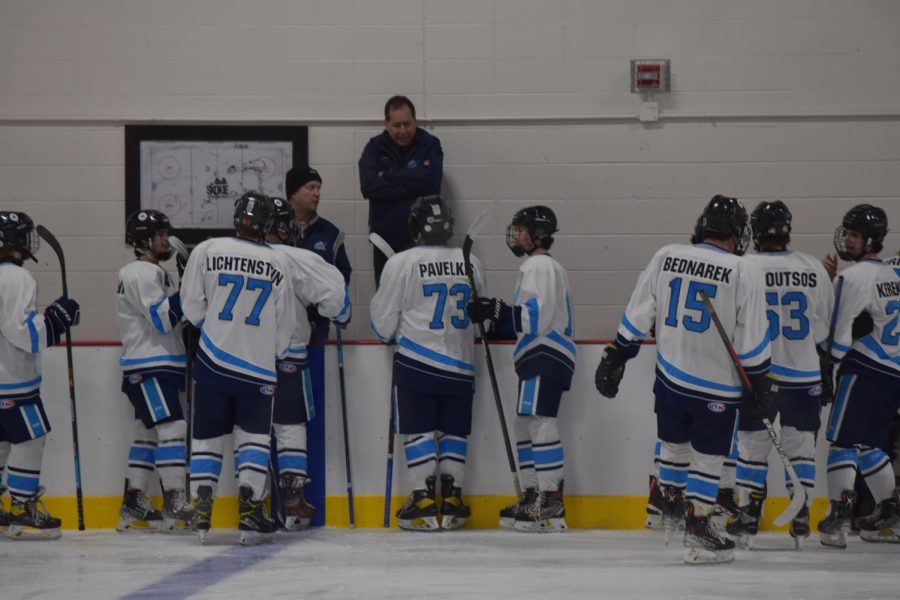 Coaches talk to the team in between the second and third period. 