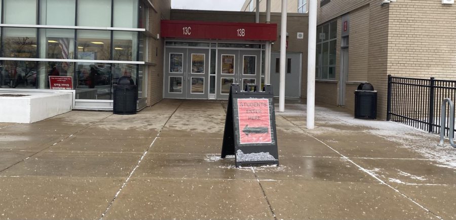 Sign at Door 13 indicating where students should enter. 